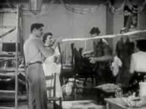 A nostalgic 1950s photo capturing a couple in a charming kitchen, perfect for Throwback Thursday reminiscing.
