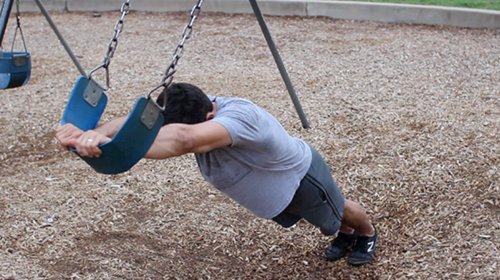 Vintage men doing ab roll Out exercise.