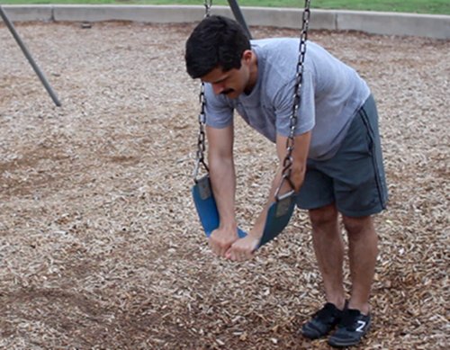 Vintage men doing ab roll out exercise.