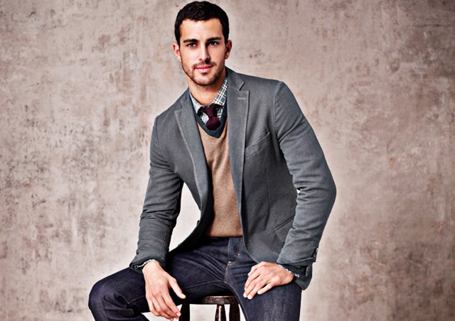 Male model in layers blazer with thin layer and button up shirt.