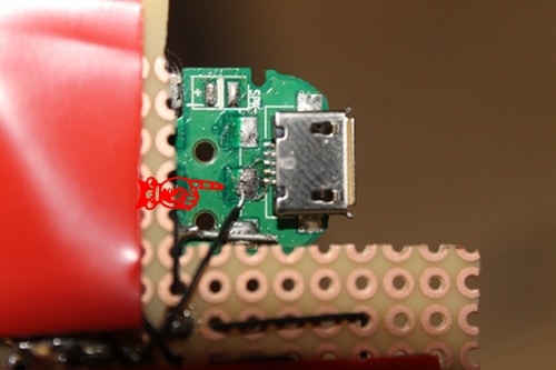 Vintage connecting a white wire to the terminal on the field phone responsible for the microphone. 