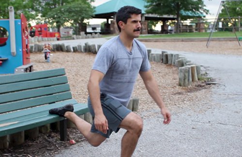 Vintage man doing Bulgarian split squat exercise.