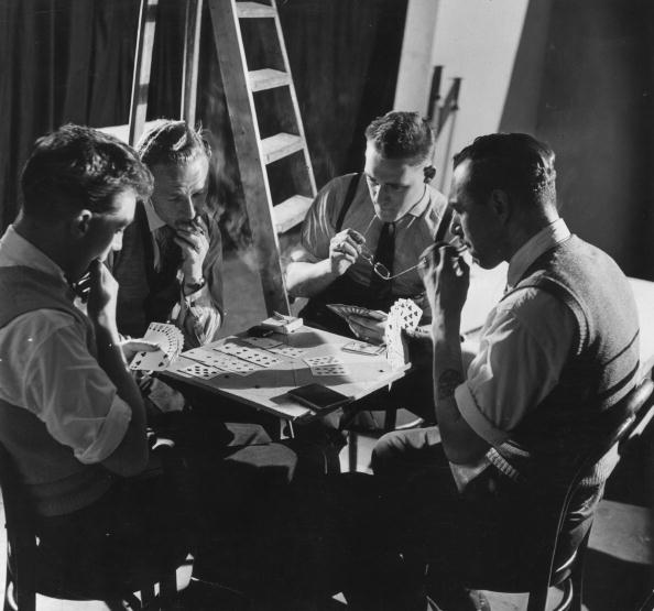 Vintage men playing cards backstage.