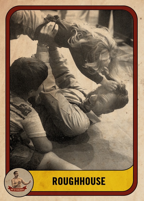 Vintage dad roughhousing wrestling with kids.