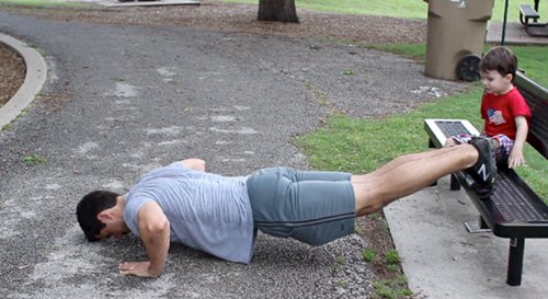 Vintage man doing decline push ups exercise.