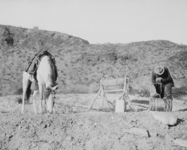 Vintage man with horse in desert.