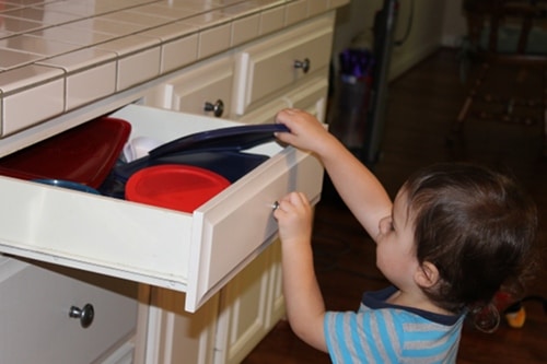IMG_1070 Young boy doing chores putting dishes away kitchen.
