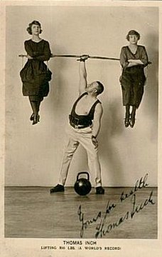 An old photo of a man and two women participating in balanced strength training with a kettlebell exercise.