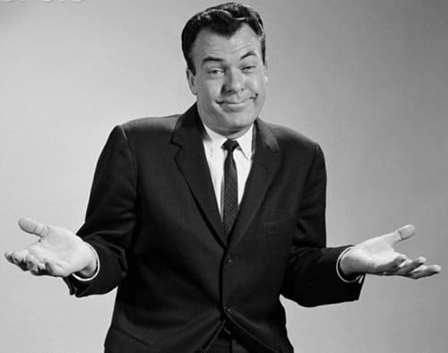 A black and white photo of a man in a suit, suitable for online comment.