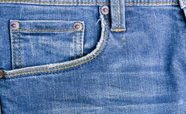 The jeans pocket is stitched onto the pants.