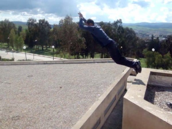 Man jumping from rooftops. 