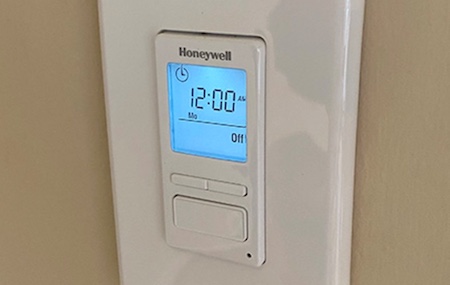 A Honeywell programmable timer is mounted on a wall.