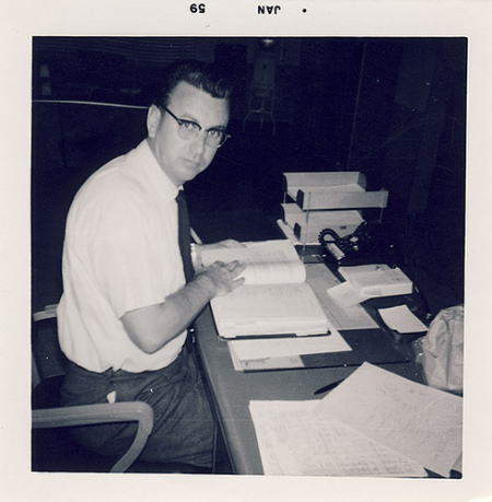 mandesk Vintage man sitting at desk with a textbook.