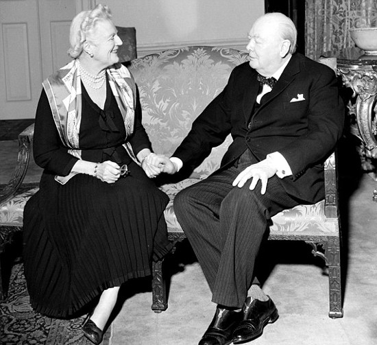 Winston and clementine Churchill sitting on small couch.