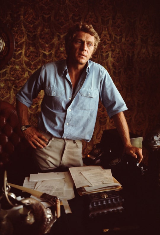 Steve mcqueen standing in the office.