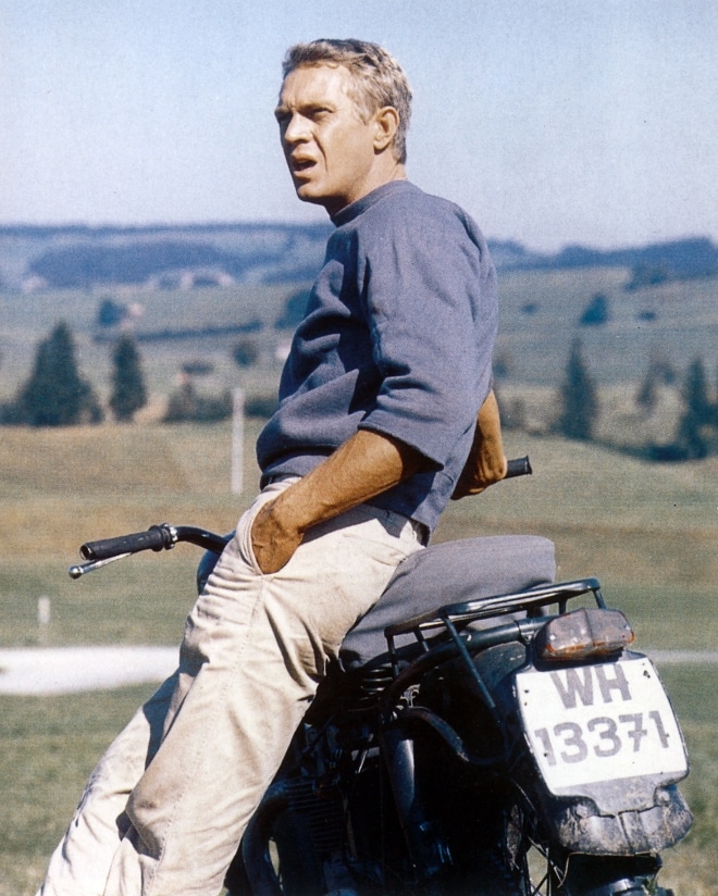The side view of Steve mcqueen with motorcycle.