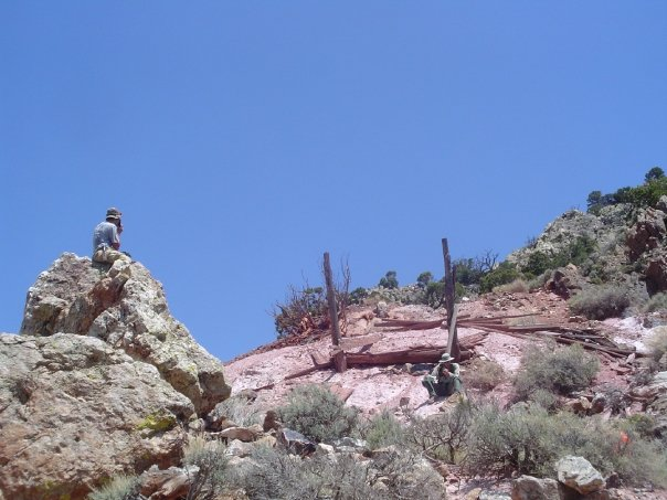 Archaeologist Archaeologist sitting on a rock at a site.