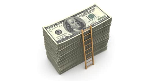 A small ladder leaning against a large stack of 100-dollar bills symbolizes climbing the levels of wealth on a white background.