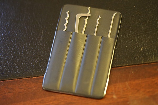 Wallet-sized, titanium made lock pick.