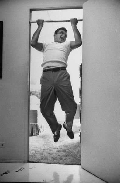 pullpups Vintage man enjoying while doing pull ups in doorway.