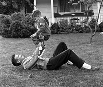 roughhousing2 Vintage dad outside with son pushups exercise.