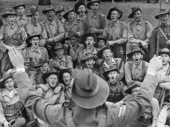 Soldier is giving instrutions to his group.