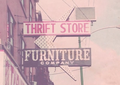 Thrift store sign offering top-quality furniture products and thrifting tips.