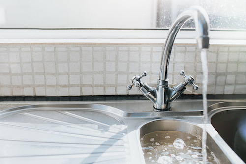 A kitchen sink with a faucet to increase water pressure at home.